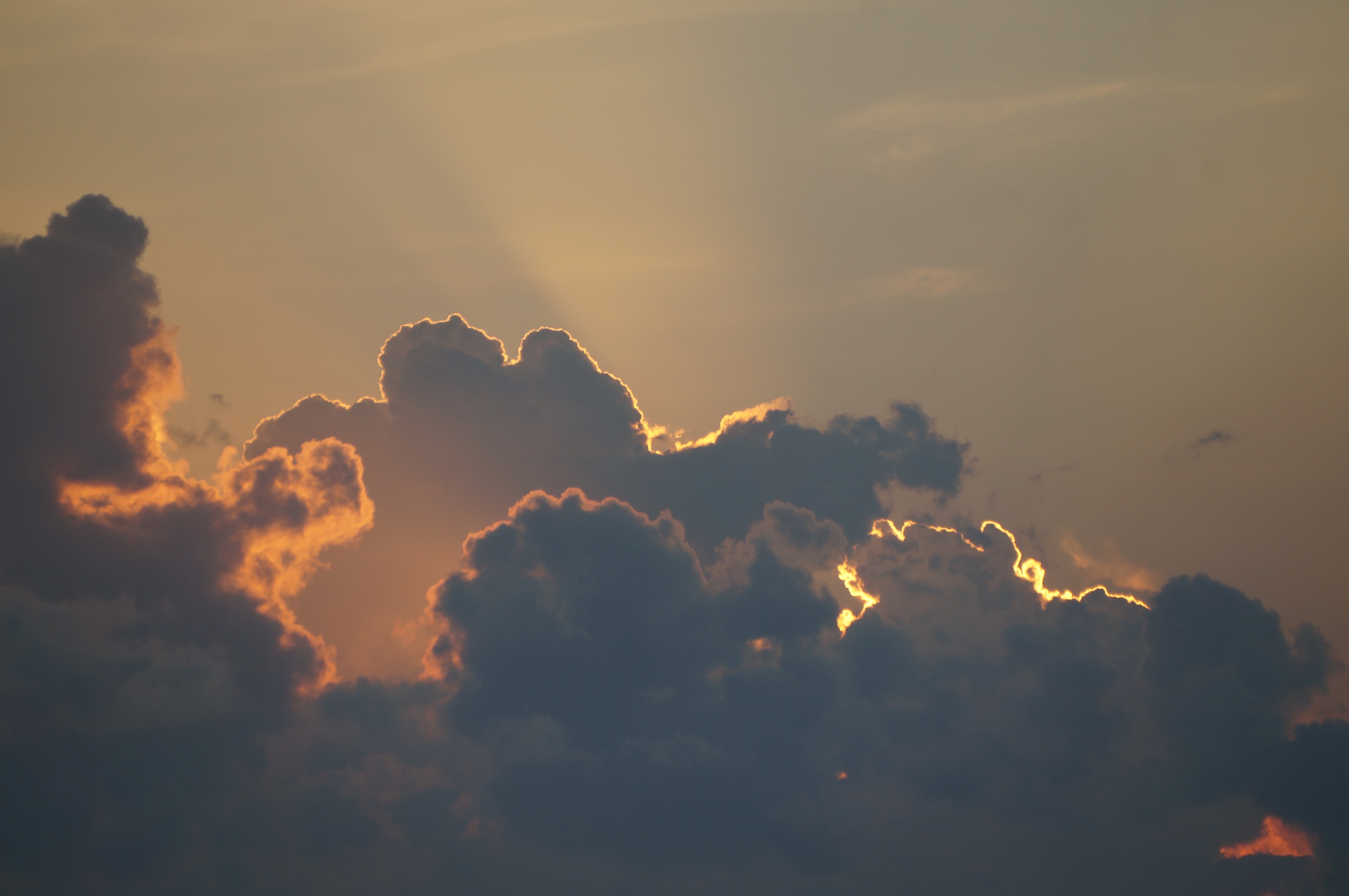Storm clouds with sun behind